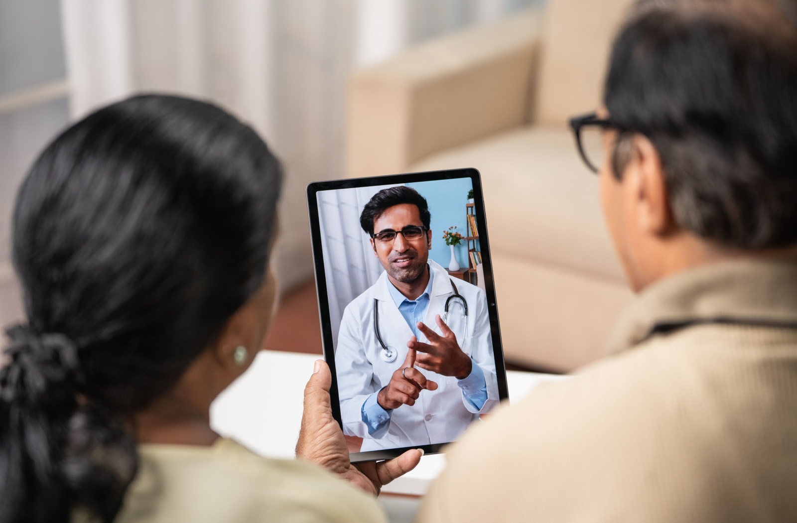 A family speaking with a doctor for an update on their loved one's health.