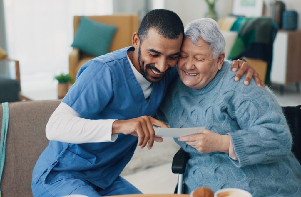 A memory care staff member hugs a resident while they review a document, helping them feel confident and safe.