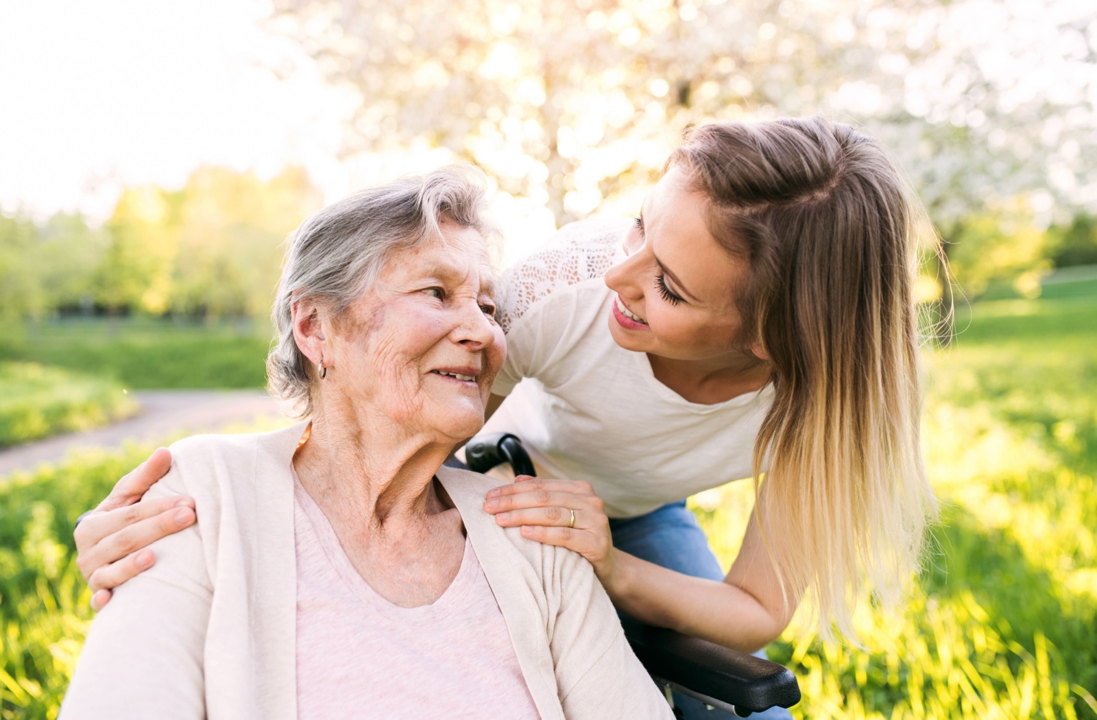 A grandchild and grandparent spend time together outdoors in the summer.