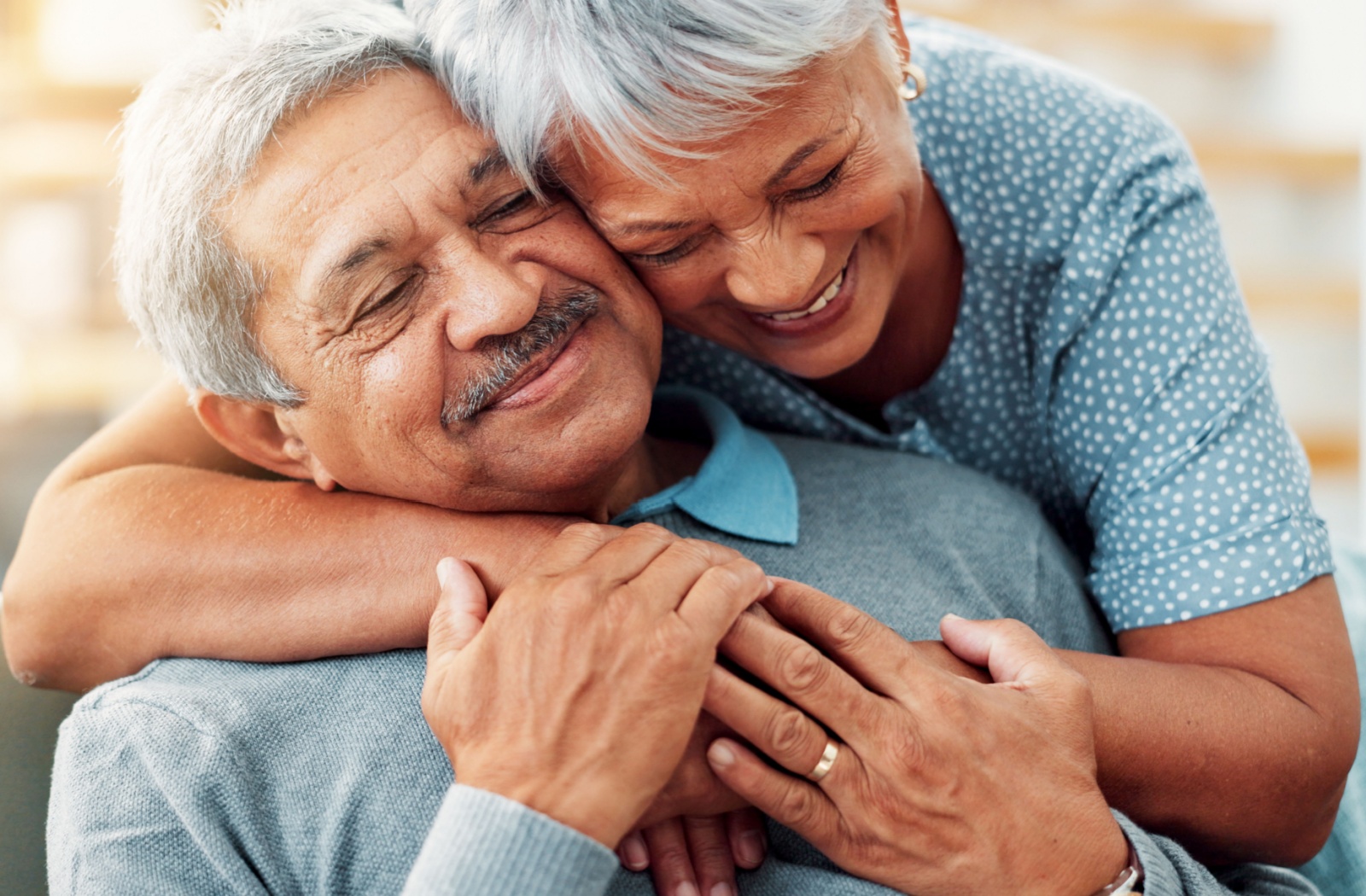 Two older adults share a joyful embrace early stage dementia support concept memory care planning warm moment