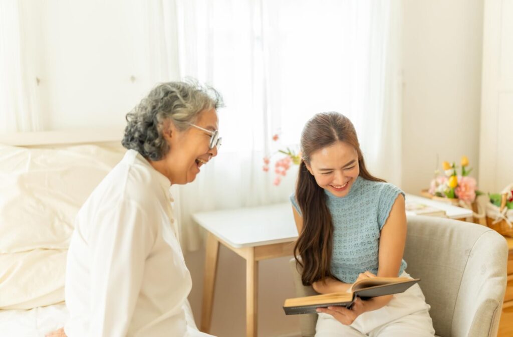 Adult child and senior reading together in bright room early stage dementia memory care emotional support activity